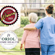 A caregiver walks arm-in-arm with an older adult outdoors, with the Oriol Home Health logo and a “Best of Your Hometown 2025 Winner” seal displayed.