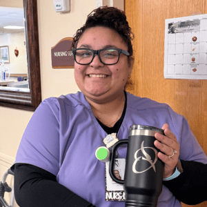 Adriana Rivera, LPN – February Employee of the Month | Oakdale Rehabilitation Adriana Rivera, LPN at Oakdale Rehabilitation & Skilled Nursing Center, smiling in uniform while holding a branded Oriol Health Care mug.