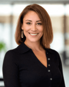 Tara D’Andrea, Director of Operations, smiling in professional headshot wearing a black top